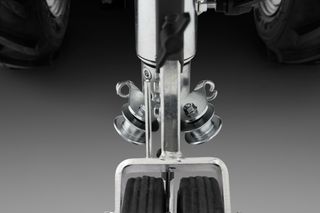 Close-up view of a construction tool with wheels and metal components.