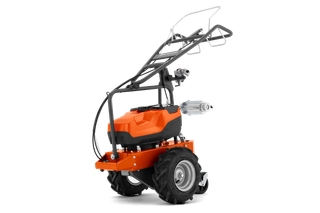 Side view of a construction power tool with large wheels and a handle for maneuverability.