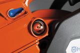 Close-up view of a Husqvarna chainsaw featuring the fuel pump bulb.