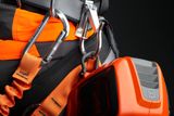 Close-up of a Husqvarna product with safety harness and carabiners.