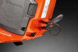 Close-up view of a Husqvarna product component with a pull ring.