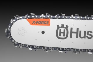 Close-up of a Husqvarna chainsaw blade with X-Force branding.