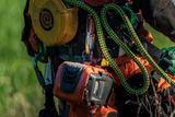 Close-up of a construction worker's tool belt with various tools and equipment.