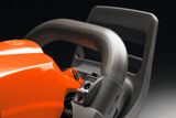 Close-up of a Husqvarna product's handle and control button.