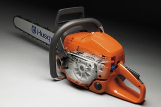 Side view of a Husqvarna chainsaw with visible internal components.