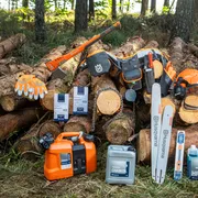 A collection of Husqvarna chainsaw accessories including a chain, oil, and protective gloves, set against a backdrop of stacked tree logs in a forest setting.