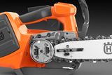 Side view of a Husqvarna chainsaw showcasing the chain and sprocket mechanism.