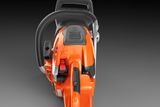 Top view of a Husqvarna chainsaw showcasing its ergonomic handle and control buttons.