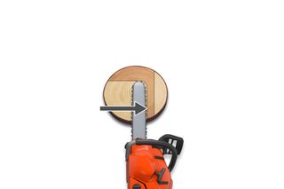 Top view of a chainsaw cutting through a wooden log.