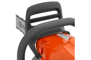 Close-up view of a Husqvarna chainsaw handle and chain.