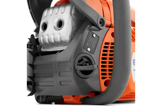 Close-up view of a chainsaw's engine and control panel.