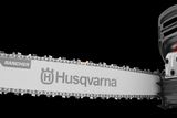 Side view of a Husqvarna chainsaw with a visible blade and handle.