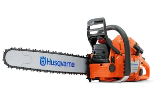 Side view of a Husqvarna chainsaw with a visible chain and brand logo.