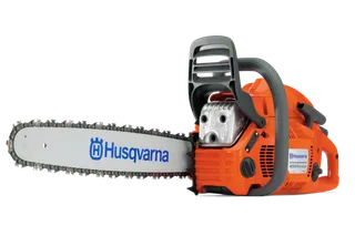 Side view of a Husqvarna chainsaw with visible branding and blade.