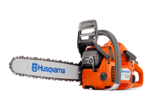 Side view of a Husqvarna chainsaw with visible branding on the blade.