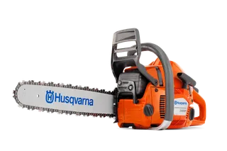 Side view of a Husqvarna chainsaw with visible branding on the blade.