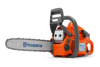 Side view of a Husqvarna chainsaw, showcasing its ergonomic handle and cutting chain.