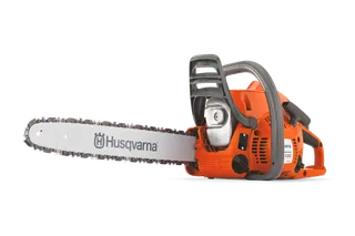 Side view of a Husqvarna chainsaw with visible branding on the blade.