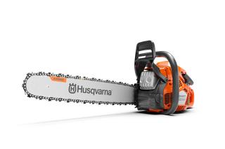 Side view of a Husqvarna chainsaw with X-Precision branding on the blade.