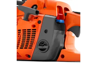 Close-up view of a chainsaw's side panel showing controls and air filter cover.