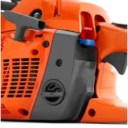 Close-up view of a chainsaw's side panel showing controls and air filter cover.