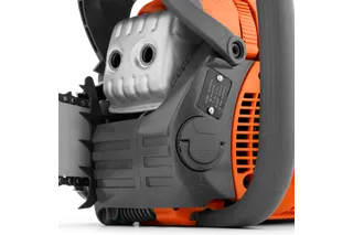 Close-up view of a chainsaw engine and part of the chain bar.