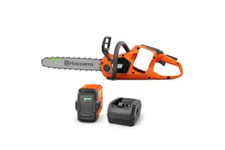 Husqvarna 435i. Side view of a Husqvarna battery-powered chainsaw with a battery and charger.