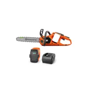 Husqvarna 435i. Side view of a Husqvarna battery-powered chainsaw with a battery and charger.