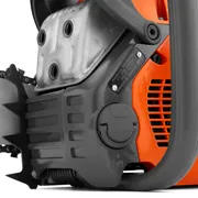 Close-up view of a chainsaw engine and oil cap, showcasing mechanical details.