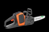 Side view of a Husqvarna chainsaw with guide bar and chain visible.