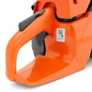 Close-up view of a chainsaw handle with a QR code visible.