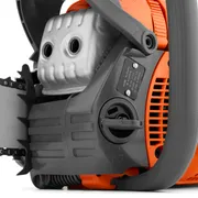 Close-up view of a chainsaw engine and handle, showcasing the air filter and control panel.