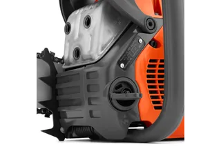 Close-up view of a chainsaw engine, showcasing its components.