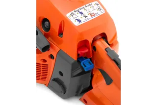 Close-up view of a chainsaw with a starting guide sticker showing operational instructions.