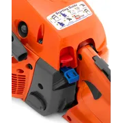 Close-up view of a chainsaw with a starting guide sticker showing operational instructions.