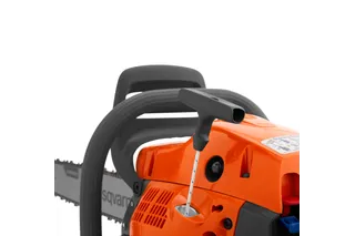 Close-up view of a chainsaw starter handle and engine casing.