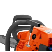 Close-up view of a chainsaw starter handle and engine casing.