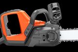 Side view of a Husqvarna chainsaw with visible branding on the blade.