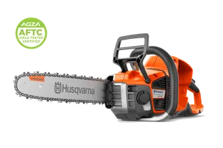 Side view of a Husqvarna chainsaw with guide bar and chain, studio shot with AGZA AFTC badge.
