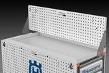 Husqvarna branded workbench with a perforated back panel for tool organization.