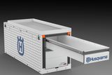 Side view of a Husqvarna storage drawer unit with a perforated design.
