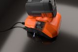 Close-up of a Husqvarna battery charger with a cooling fan in operation.