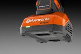 Close-up of a Husqvarna C750X battery charger with branding visible.