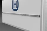 Close-up of a Husqvarna product with a row of small lights or indicators on a panel.