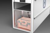 Storage compartment with a Husqvarna branded case inside.