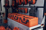 A variety of construction tools and accessories organized on a wall-mounted rack.