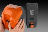 Hands holding a Husqvarna battery, with a separate view of the battery's casing.