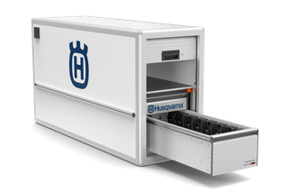 Front view of a Husqvarna battery charging station with multiple batteries.
