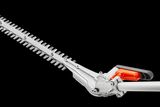 Side view of a hedge trimmer attachment with an adjustable angle feature.