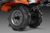 Close-up view of rugged wheels on a Husqvarna garden tiller.